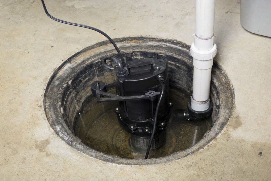 Submersible sump pump in an open sump pit in a basement floor
